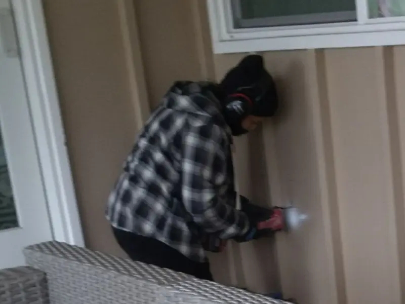 Professional electrician installing an exterior outlet in Elk